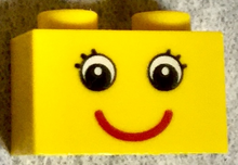Part 3004pb086 - Brick 1 x 2 with Eyes with Eyelashes and Red Smile Pattern - De BrickPlaats